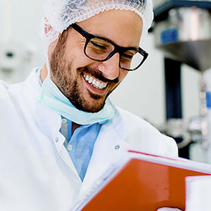 health sciences professional smiling while reviewing files