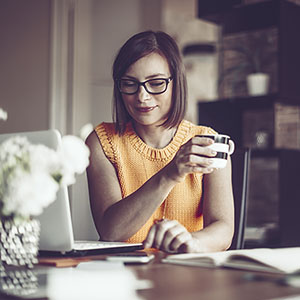 business administration executive drinking coffee while reviewing documents
