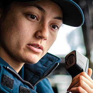 emergency and disaster management professional holding phone