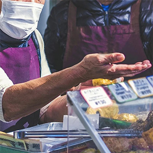 market vendor discussing food prices